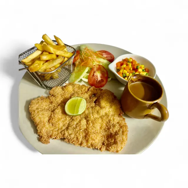 A breaded cutlet with fries, vegetables and sauce