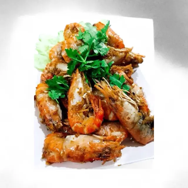 A plated seafood dish with herbs
