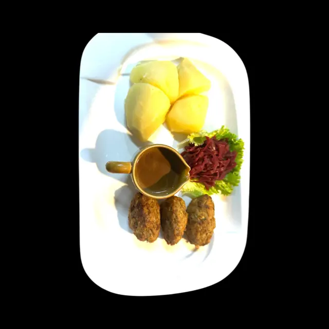 Skewers served with potatoes, salad and sauce