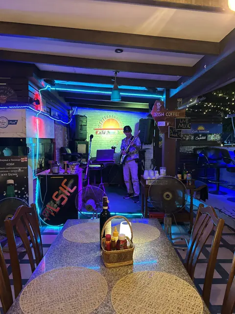 The Sunshine Cafe stage lit in blue and purple